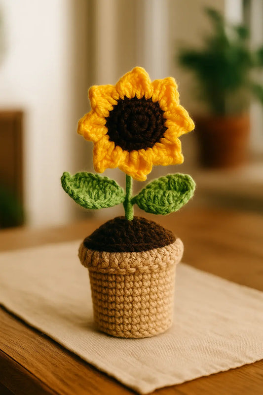 "Handmade crochet sunflower pot with bright yellow petals."